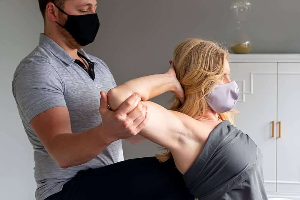 Assisted Stretching applied to client's chest area by bodyworker extending client's elbows