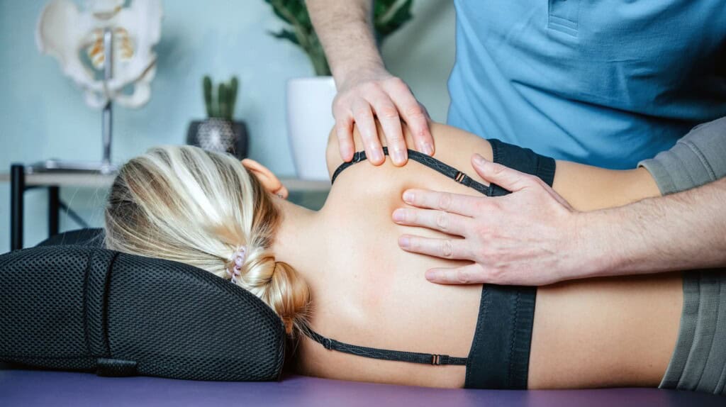 Massage therapist using myofascial release technique by applying pressure to the fascial adhesions to relieve pain.