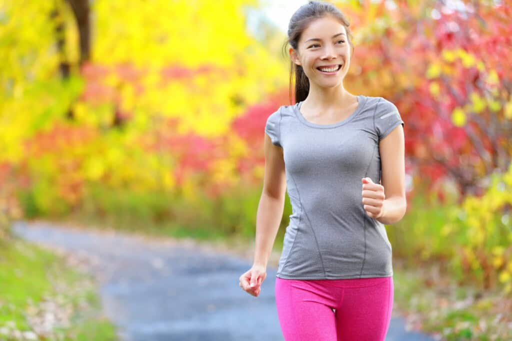 Woman happily power walking.