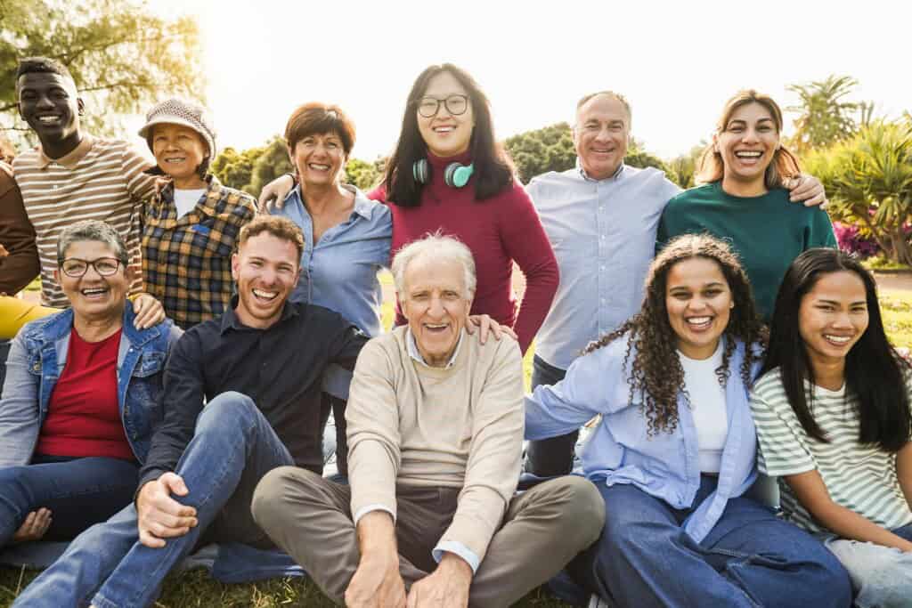 Smiling multigenerational, multiracial group enjoying time together, highlighting how bodywork benefits people of all ages and backgrounds.