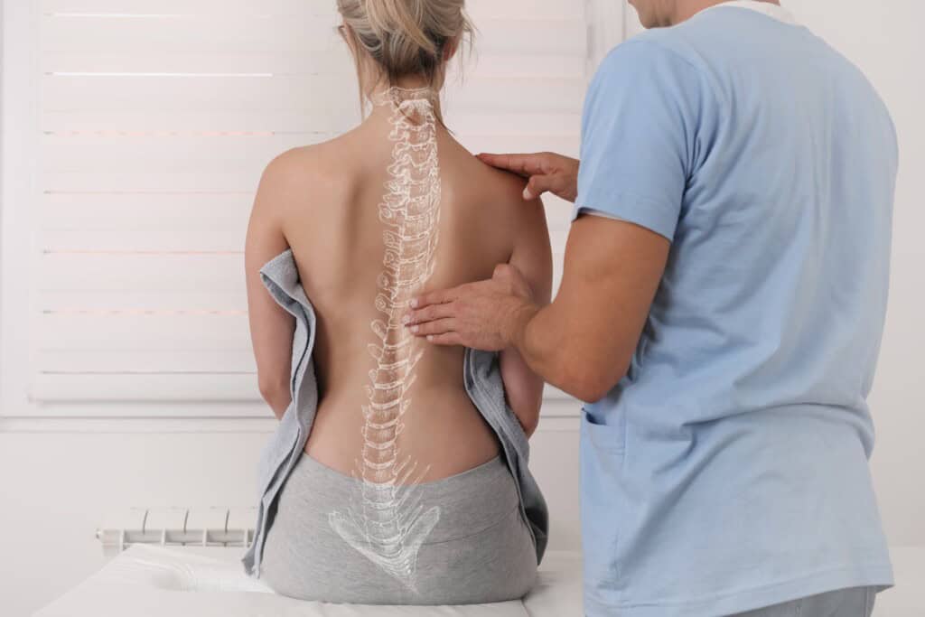 A woman undergoes a scoliosis exam, with a superimposed spine illustration highlighting the curvature of her back.